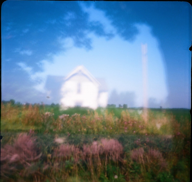 Fence row and floating house, summer 2012. Double-exposed in Clinton County, Indiana with a square-format cardboard Sharan pinhole camera on 35mm film by Laird Hunt