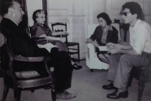 Lenin Prize recipients Pablo Neruda (later a Nobel Prize winning poet) and María Rosa Oliver hold forth while Sara Gallardo scribbles and Luis Pico Estrada looks on quizzically, <i srcset=